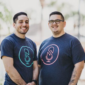 Zach and Rock posing for a photo wearing SquadCast shirts